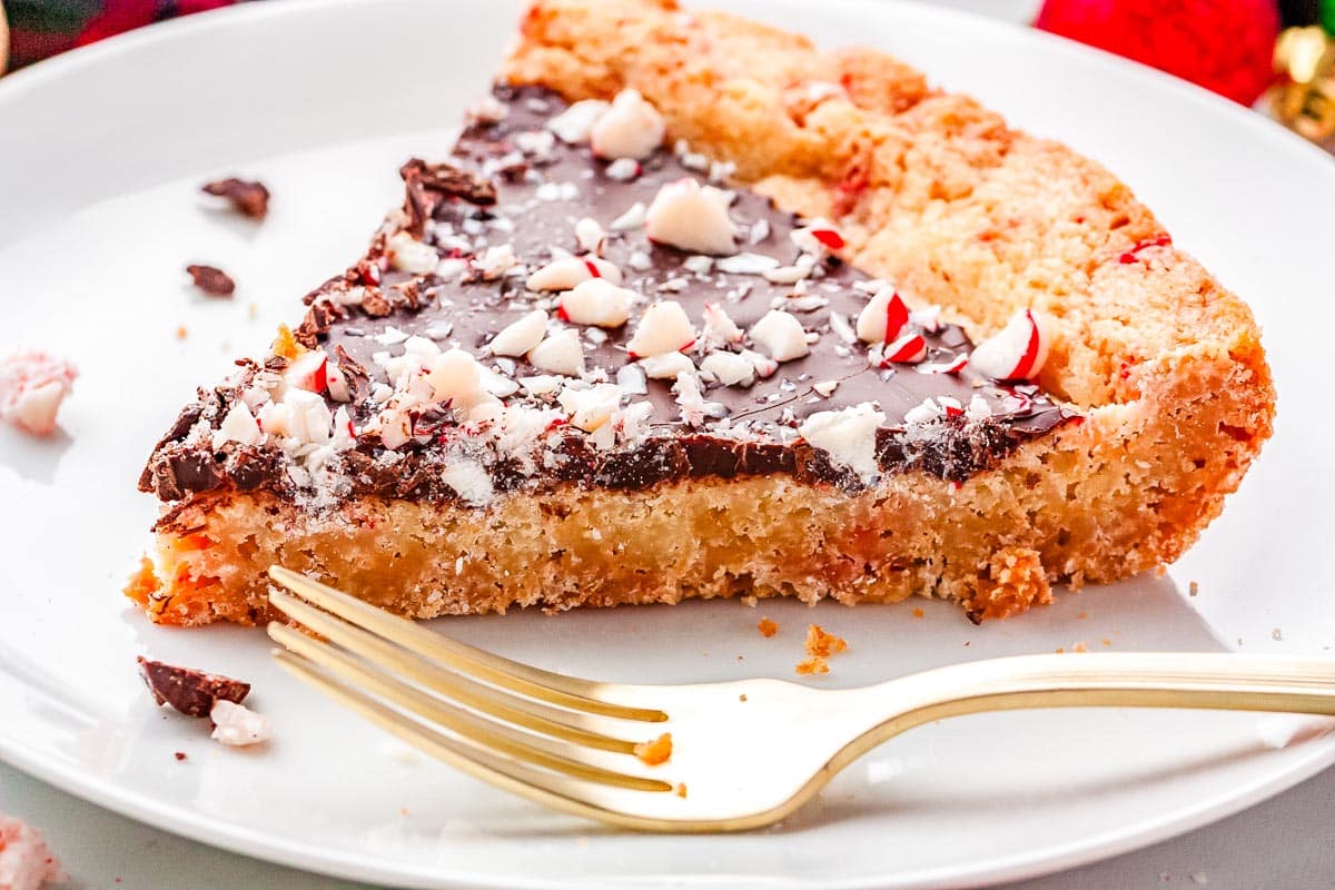 A slice of sugar cookie pie on a white plate.