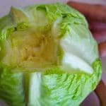 Th core cut out of a green cabbage.