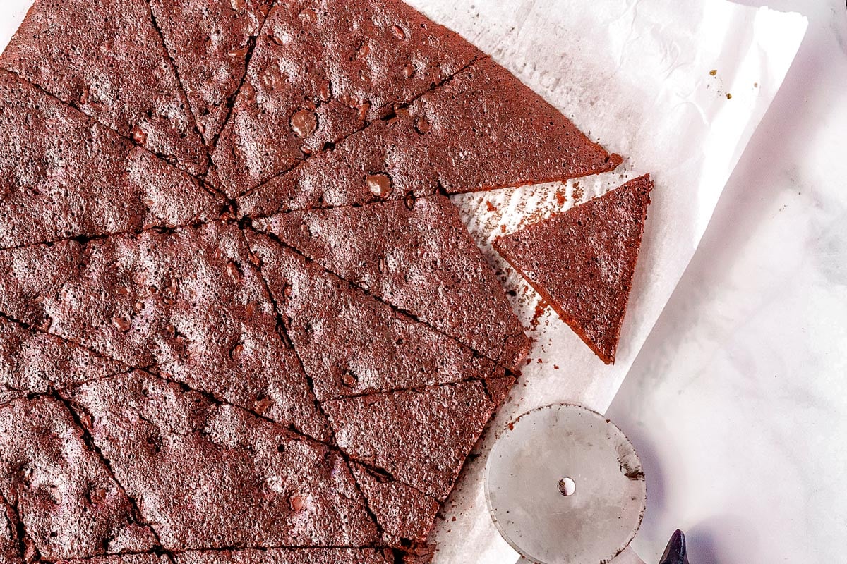 The brownie brittle cut into pieces with a pizza cutter.