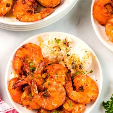 An overhead picture of garlic shrimp on a plate with rice.