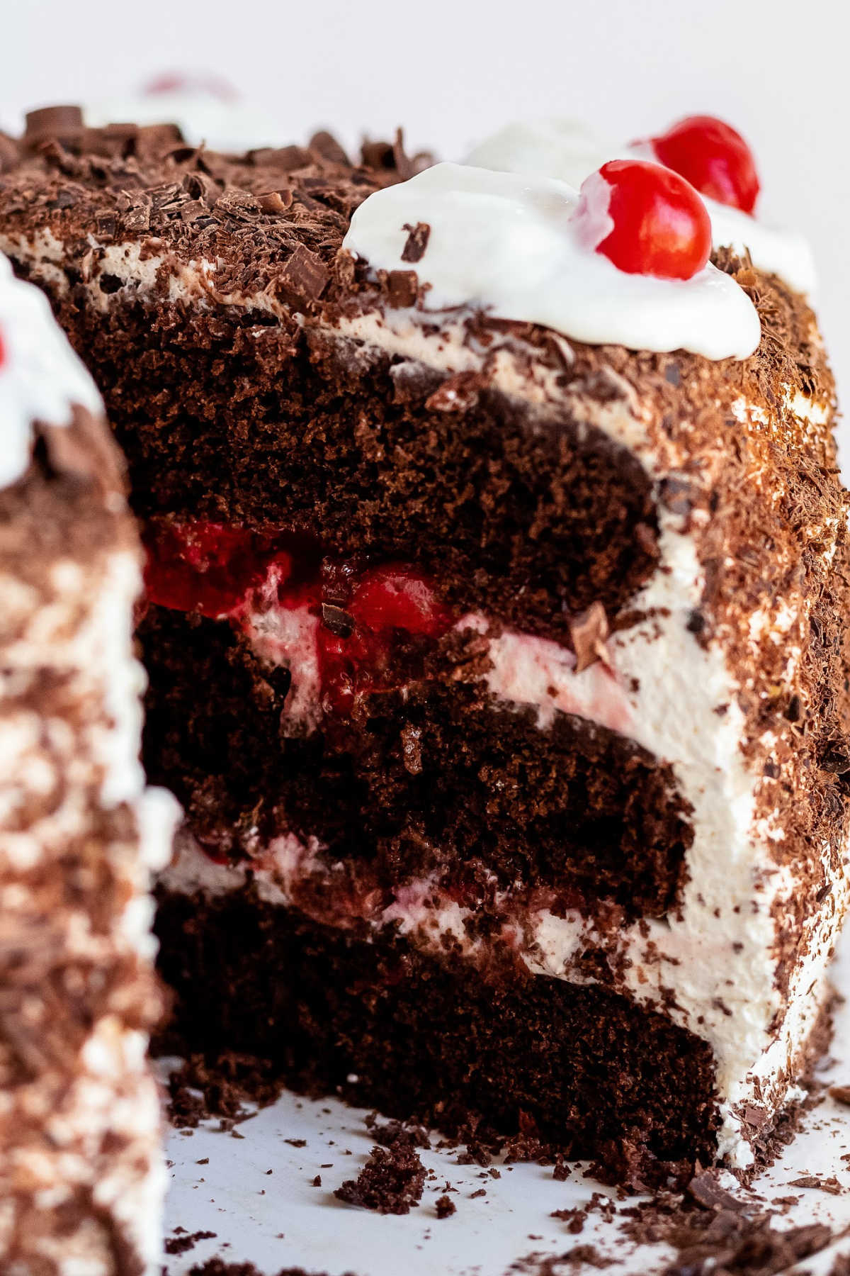 A close up picture of a slice of black forest cherry cake.
