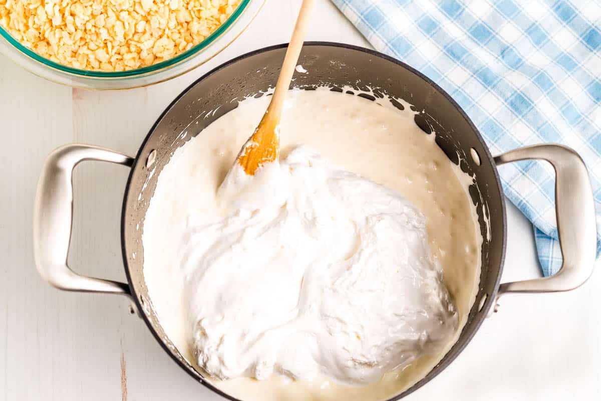 Marshmallow creme being paded ti the melted marshmallow mixture.