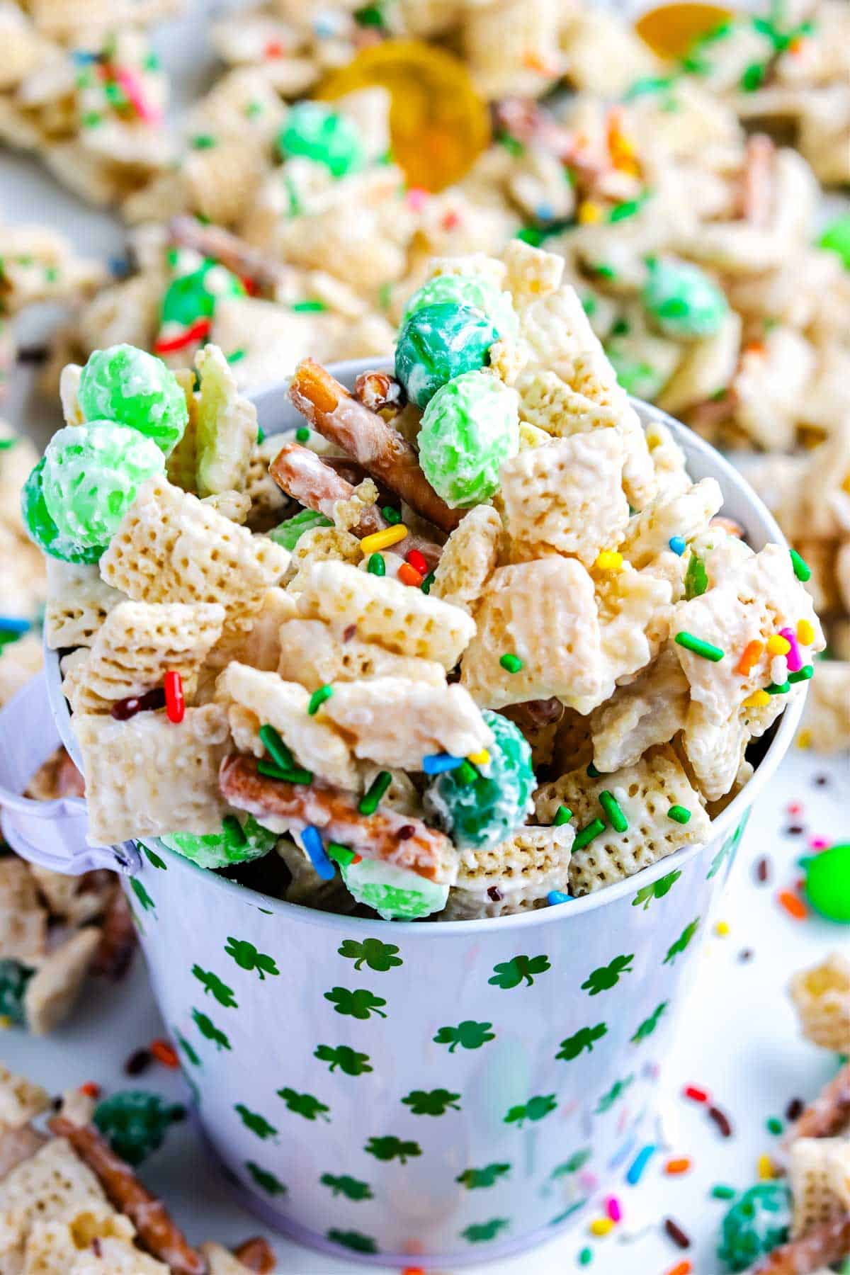 Chex mix in a St. Patrick's Day serving cup.