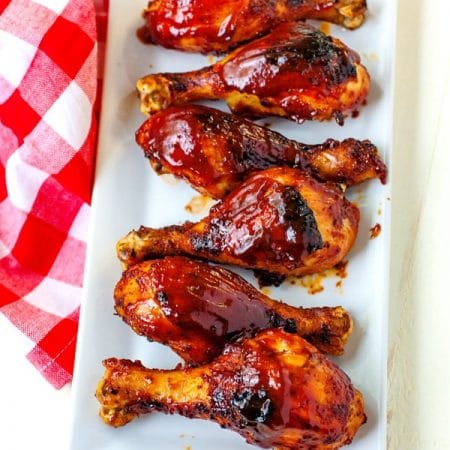 An overhead picture of Baked BBQ Chicken Drumsticks on a white platter.