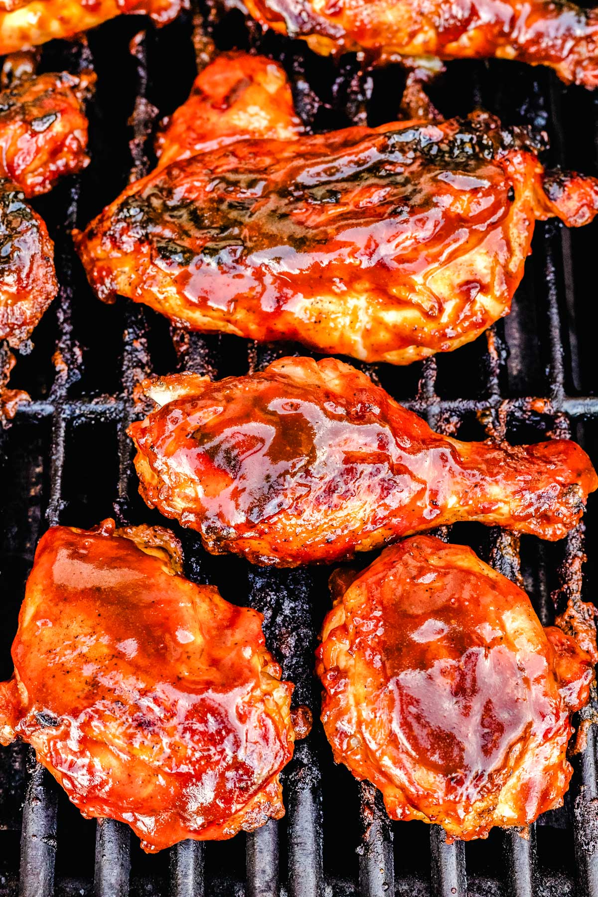 The finished BBQ chicken on grill grates.