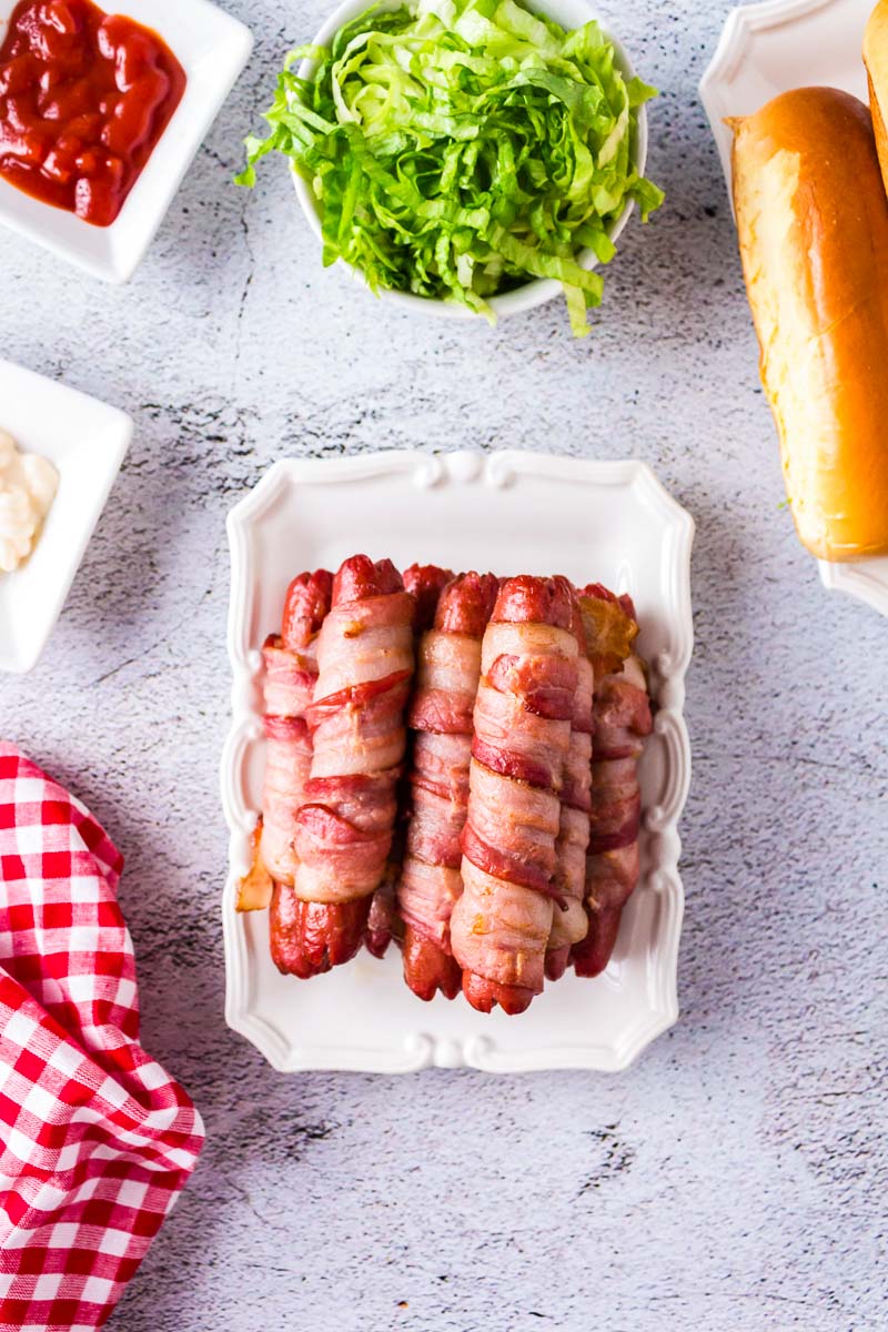 An overhead picture of Bacon Wrapped Hot Dogs on a white platter.