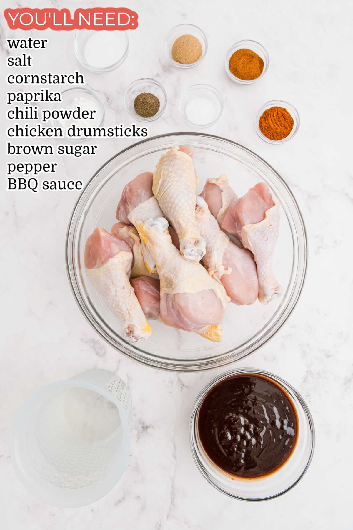 An overhead picture of all of the ingredients needed to make Baked BBQ Chicken Drumsticks.