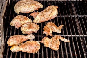 Rub the chicken with salt and pepper and place the chicken on the part of the grill with the burners that are off.