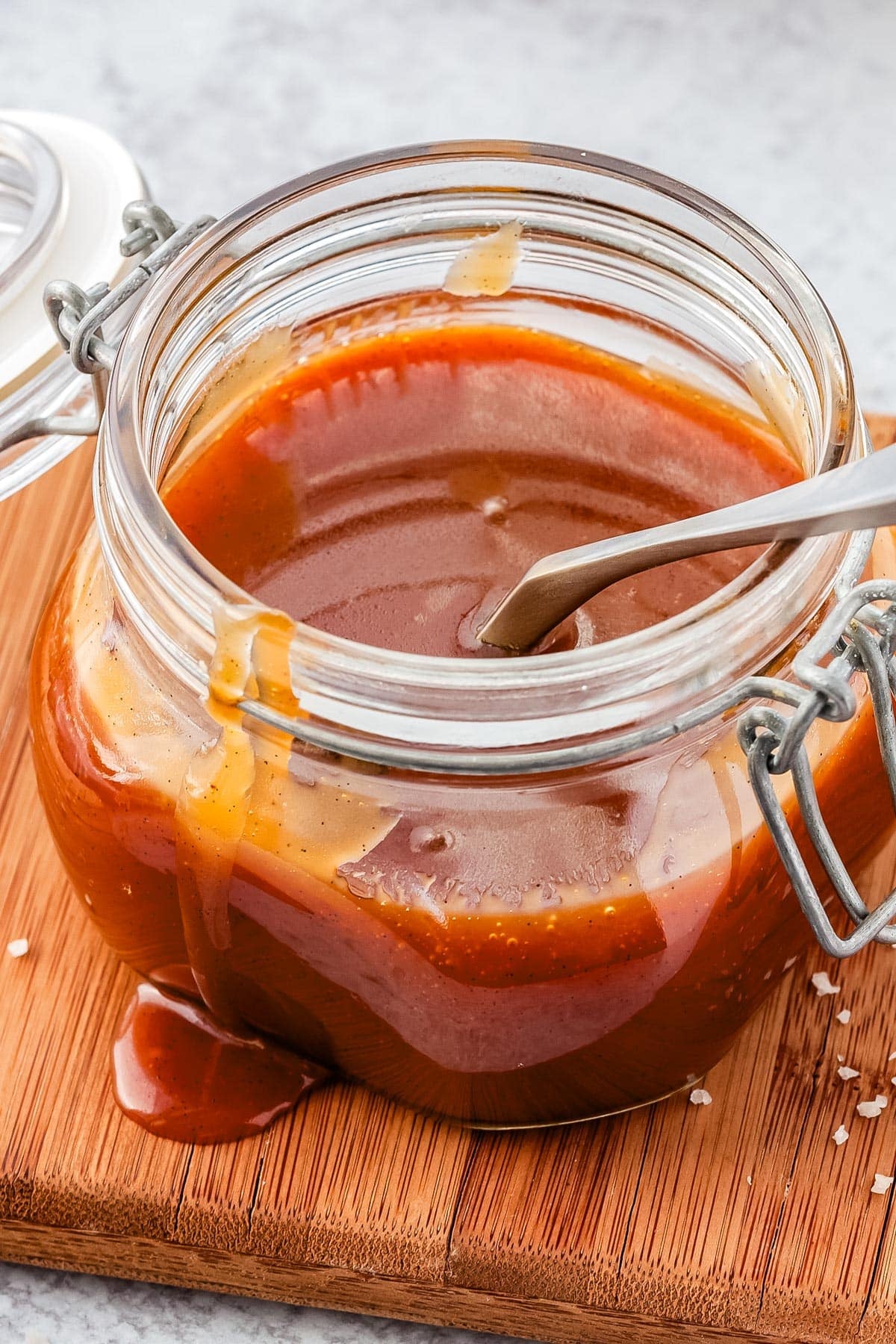 A glass jar of salted caramel sauce.