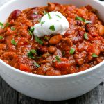 A close up picture of the finished easy crockpot chili in a white bowl.