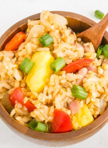 A close up picture of Hawaiian Fried Rice in a wooden bowl.