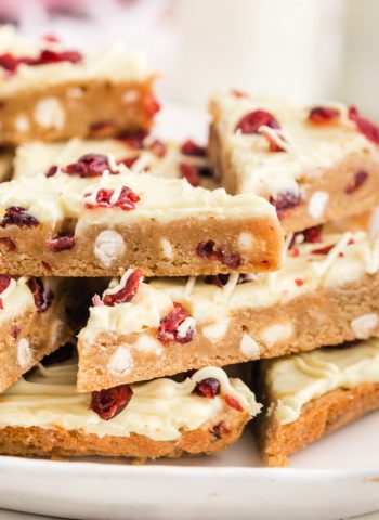A pile of Cranberry Bliss Bars on a white platter.