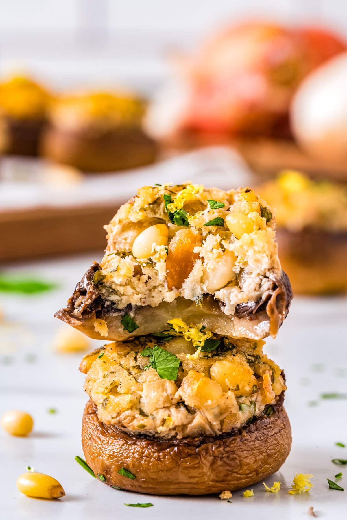Two cheese stuffed mushrooms stacked on top of each other.