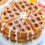 Churro Waffles with cream cheese glaze on a white plate.
