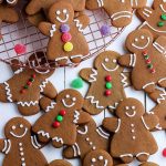 An overhead picture of simply decorated soft gingerbread cookies cutout as gingerbread men and gingerbread women.
