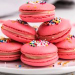 A close up picture of a stack of pink macarons.