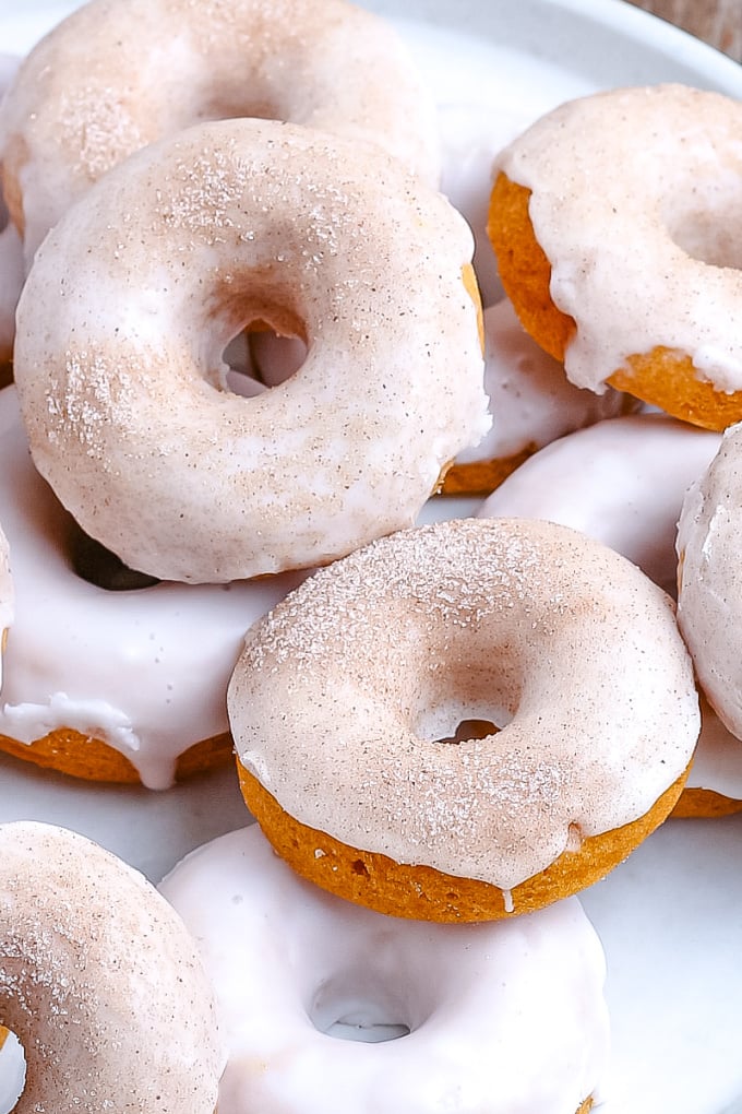 An overhead picture of a pile of glazed pumpkin donuts.