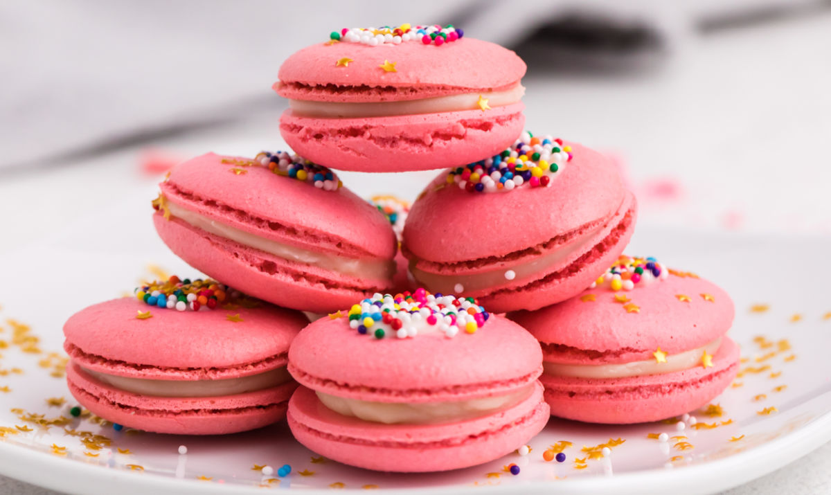 Finished white chocolate macarons stacked on top of each other.