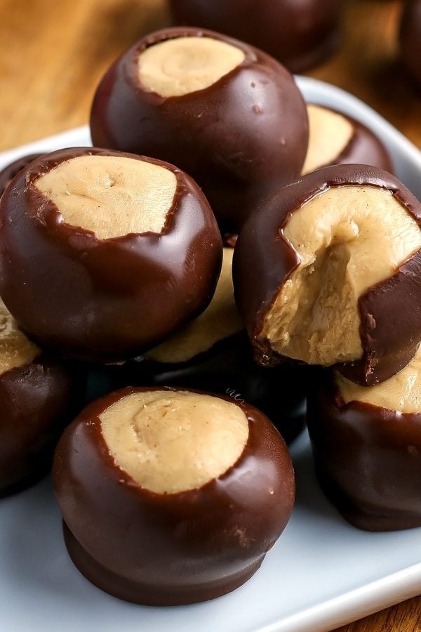 A close up of Buckeye Candy on a wooden serving platter. 
