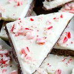 A close up picture of a triangular piece of peppermint bark.
