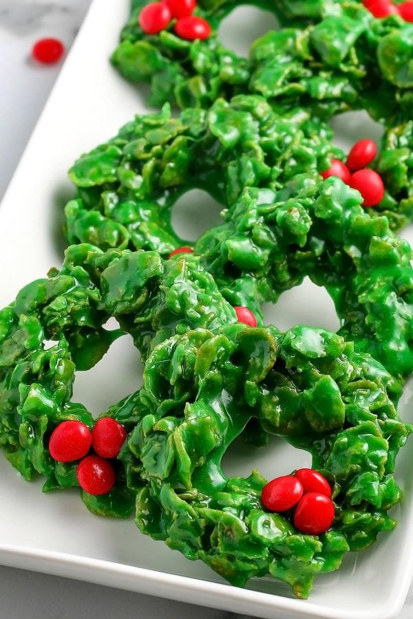 Rows of Christmas Wreath Cookies on a white serving dish.