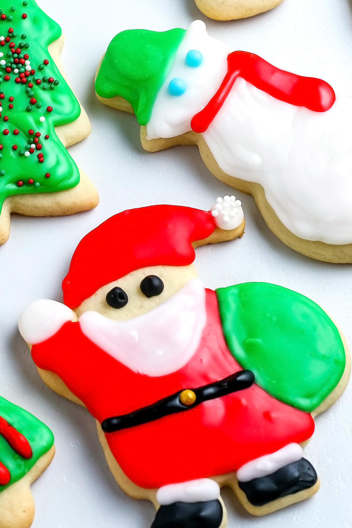 A close up picture of cut out sugar cookies decorated with icing.