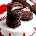 Five peppermint patties stacked on top of each other with a bite taken out of one.