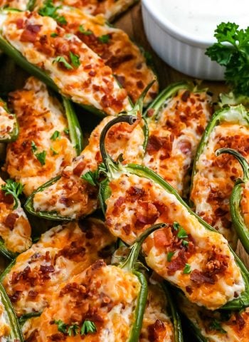 Baked Jalapeño Poppers with ranch dressing on a platter.
