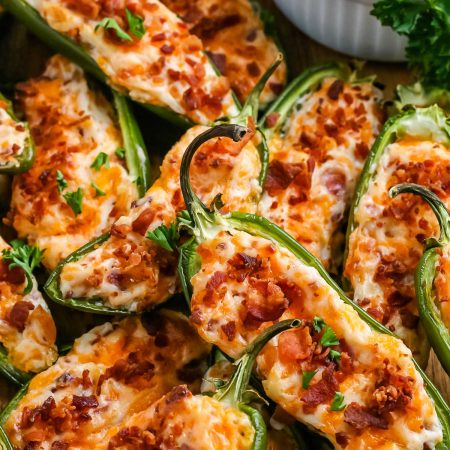 Baked Jalapeño Poppers with ranch dressing on a platter.