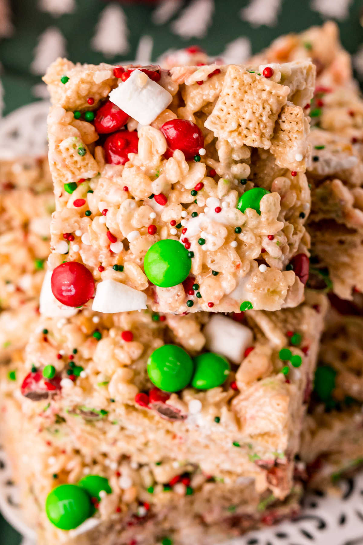 A close up picture of Christmas Rice Krispie Treats stack on top of each other.