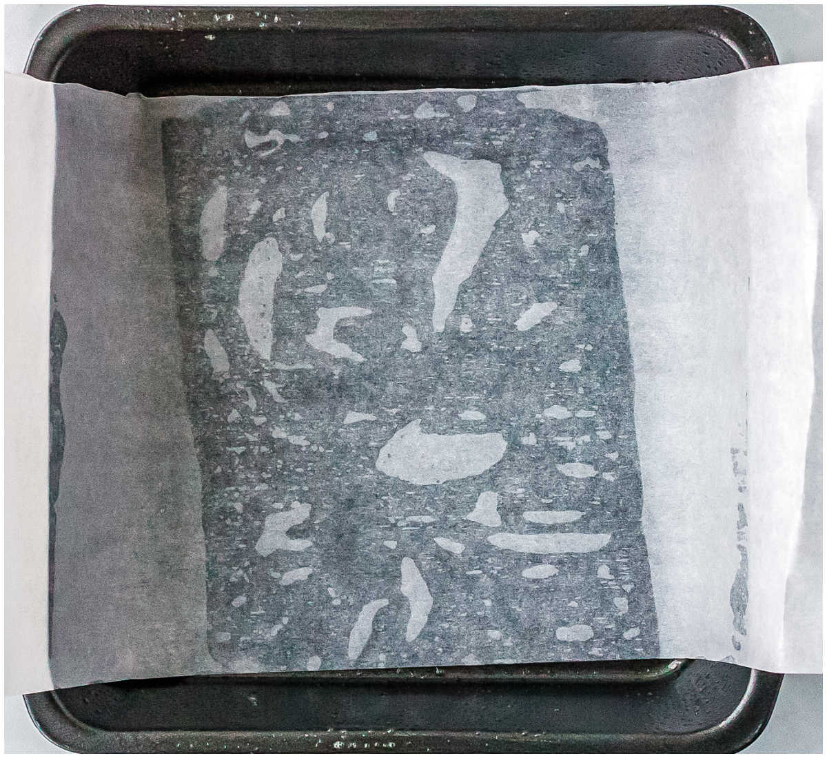 An 8 by 8 inch baking dish greased and lined with parchment paper.
