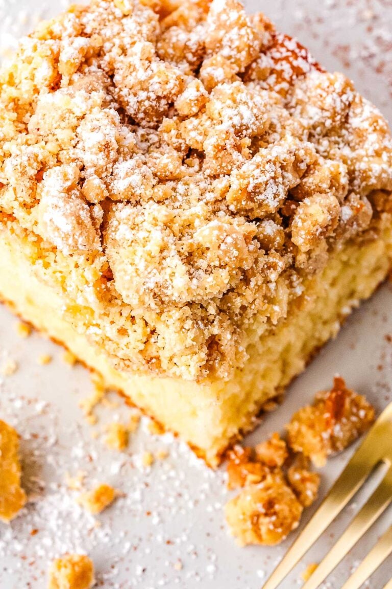 An overhead picture of a slice of New York crumb cake that focuses on the thick crumb topping.