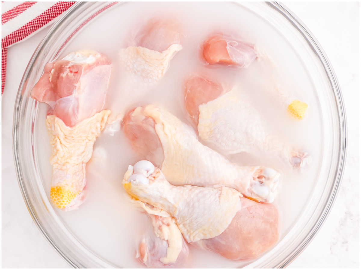 The chicken drumsticks in a water and salt brine.