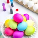 A picture of dyed Easter eggs with good coloring bottles in the background.