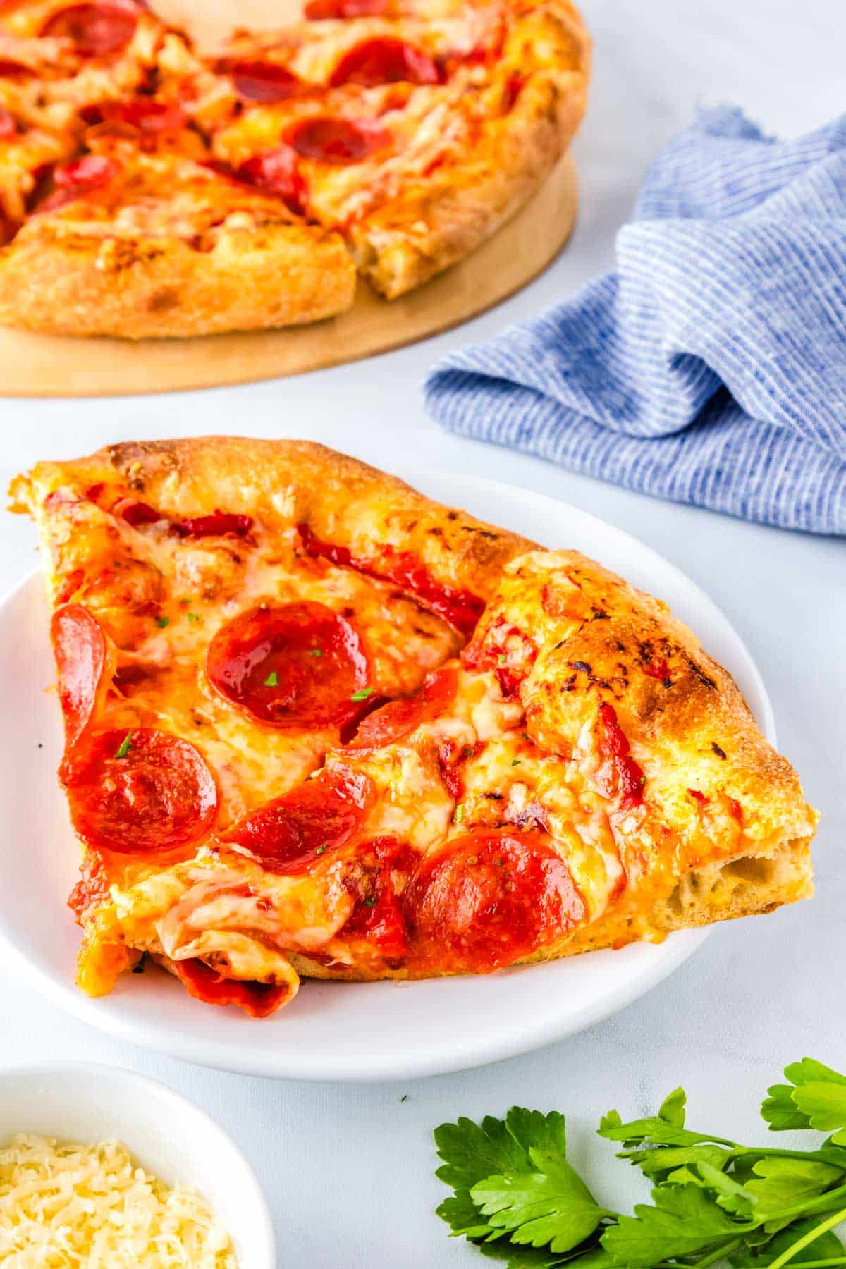Two slices of the finished pizza recipe on a white. plate.