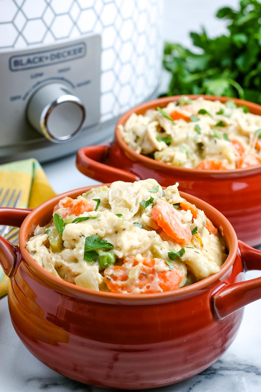 A bowl of Crockpot Chicken and Dumplings made easy using canned biscuits.