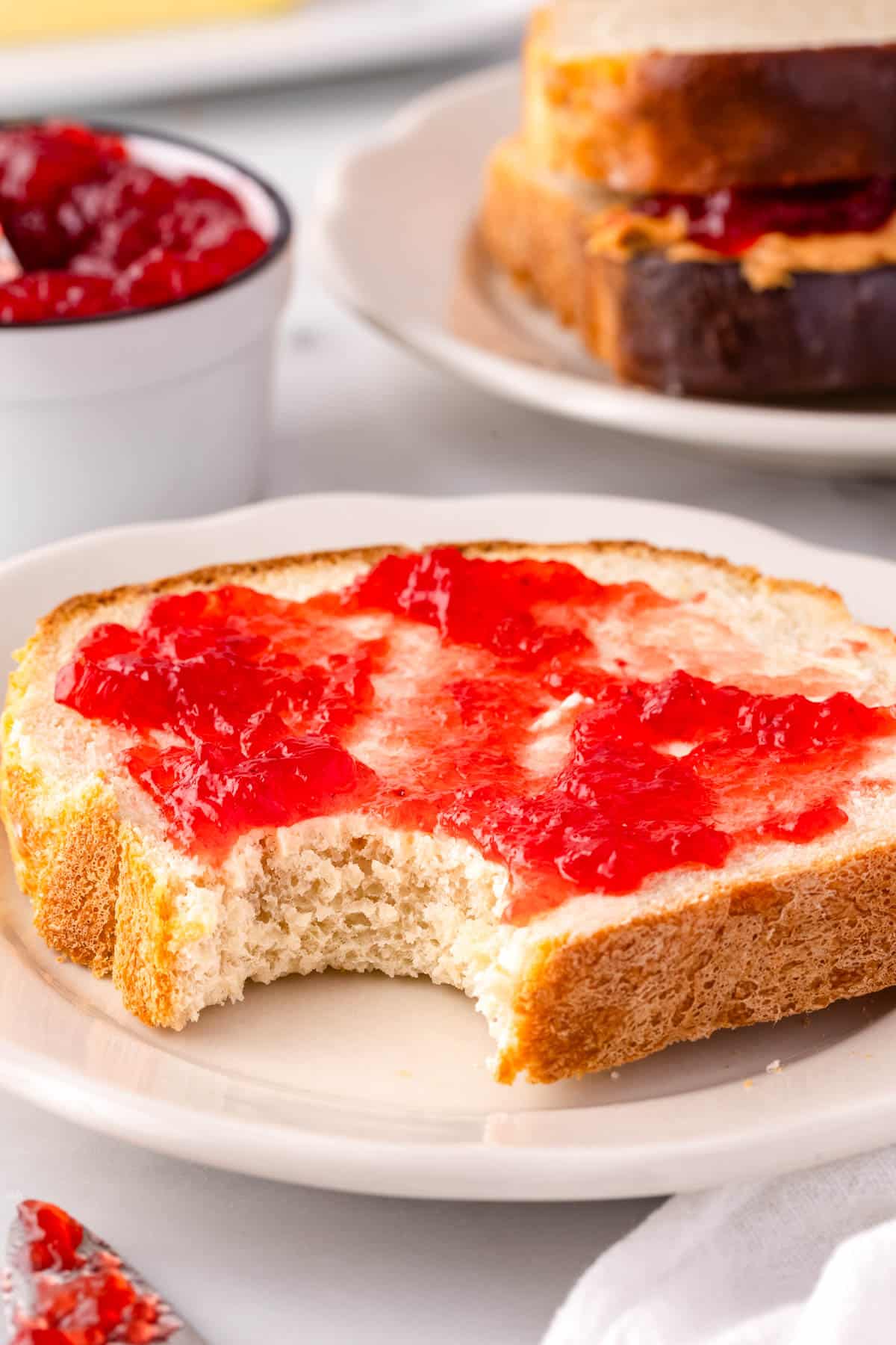 A slice of farmhouse bred with jam on it.