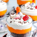 Halloween Chocolate Trifle layered with chocolate cake, vanilla pudding, Cool Whip, and Halloween candies.