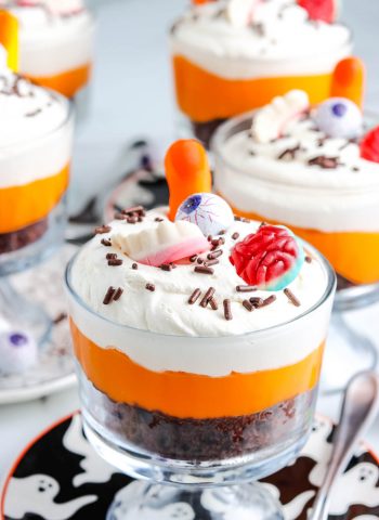 Halloween Chocolate Trifle layered with chocolate cake, vanilla pudding, Cool Whip, and Halloween candies.