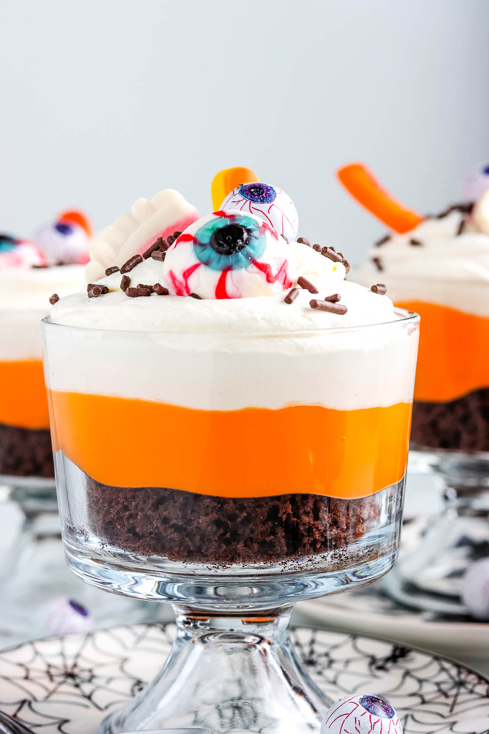 A close up picture of a finished Halloween Chocolate Trifle in a clear glass trifle dish.