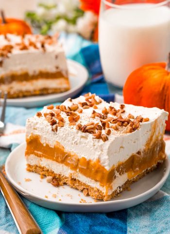 A close up picture of pumpkin delight on a white plate and a fork nearby.