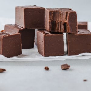 A pile of 3 Ingredient Fudge with a bite taken out of one of them.