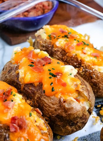 A close up picture of three finished Twice Baked Potatoes.