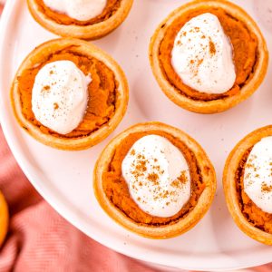 A close up overhead picture of Mini Sweet Potato Pies on a white platter.