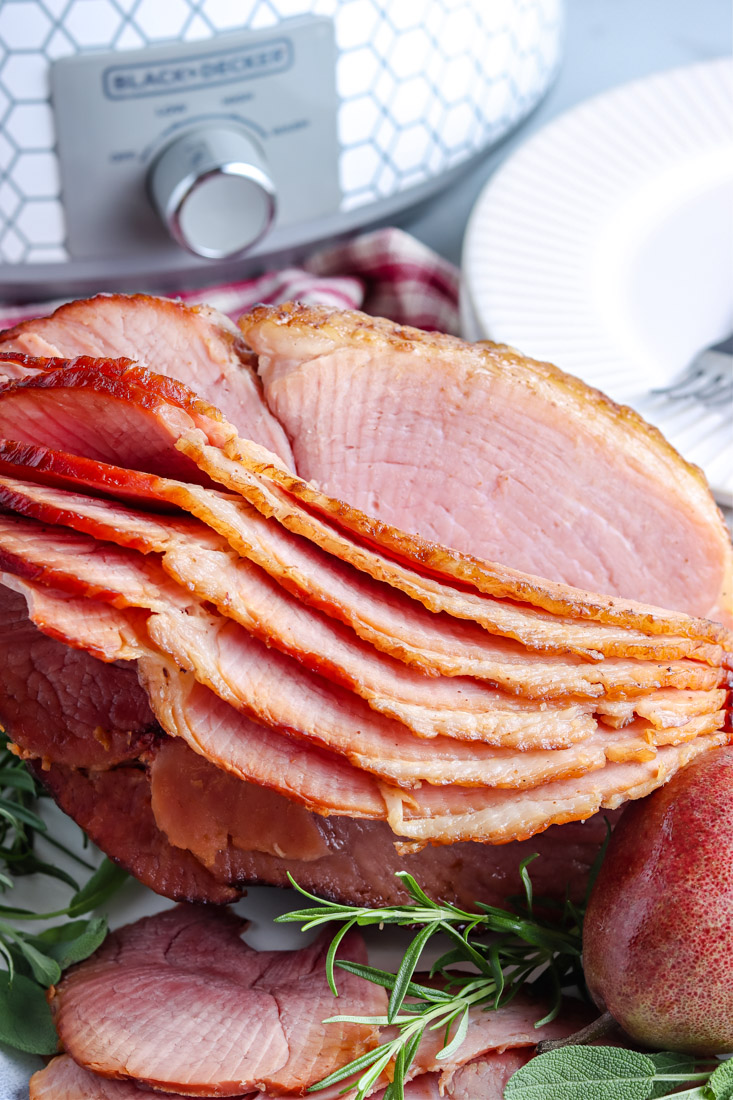 The finished Slow Cooker Spiral Ham on a white platter.