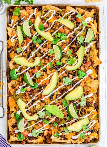 An overhead picture of the finished Ultimate Nachos Recipe on a sheet pan.