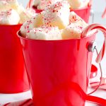 A close up picture of the finished White Chocolate Peppermint Fudge in a red mug.
