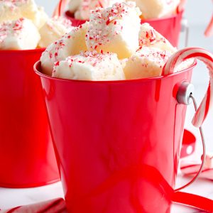 A close up picture of the finished White Chocolate Peppermint Fudge in a red mug.
