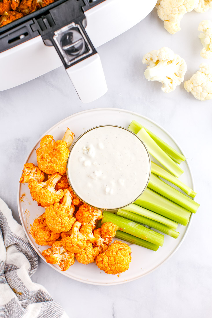 An overhead picture of the finished Air Fryer Buffalo Cauliflower on a white serving platter. 