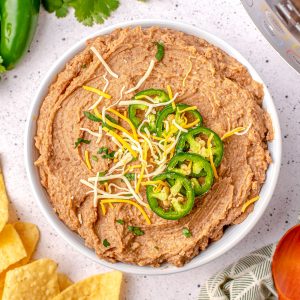 An overhead picture of the finished Instant Pot Refried Beans in a white serving bowl.